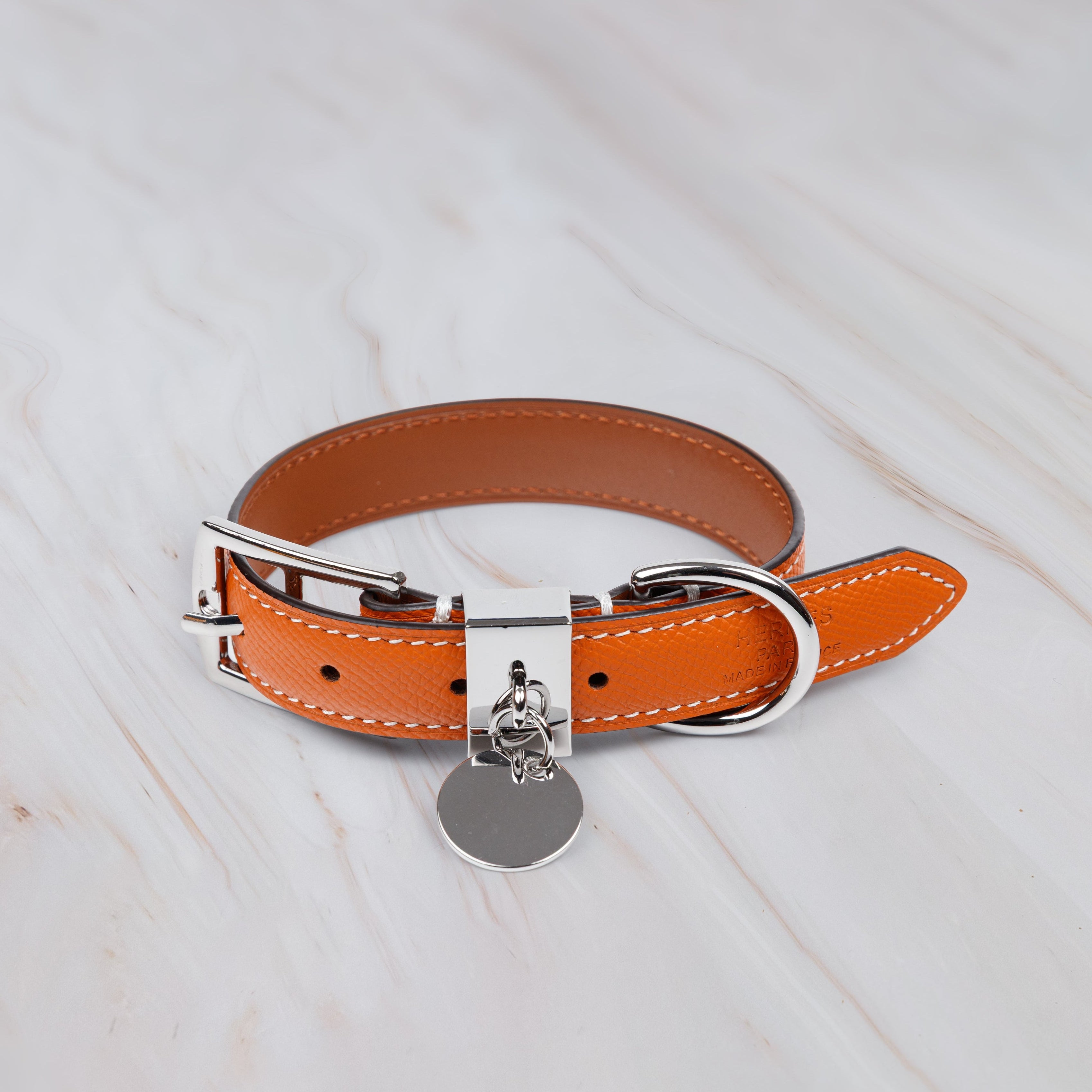 Orange leather dog collar with a silver buckle